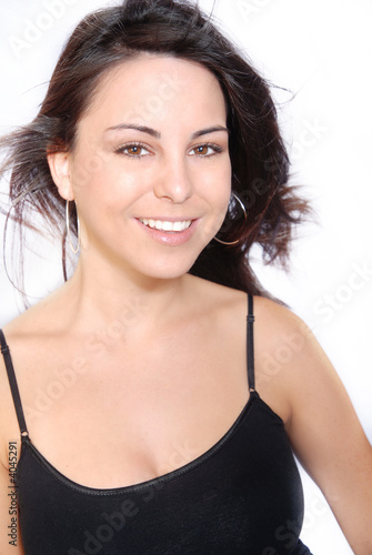 ortrait of  woman smiling with long flowing brown hair.