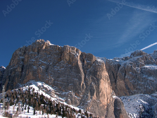 Rock mountains covered by snow and blue sky