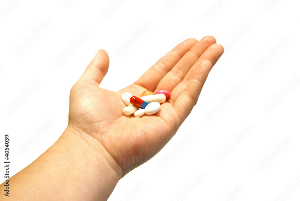 a hand is holding some pills