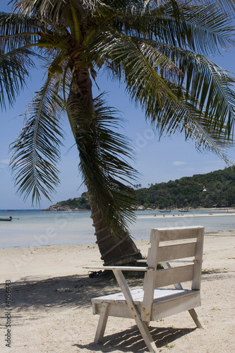 Chair at the ocean beach photo
