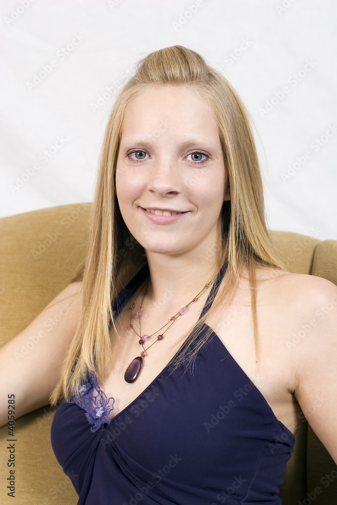 Elegant young lady sitting in a chair Elegant young lady sitting in a chair