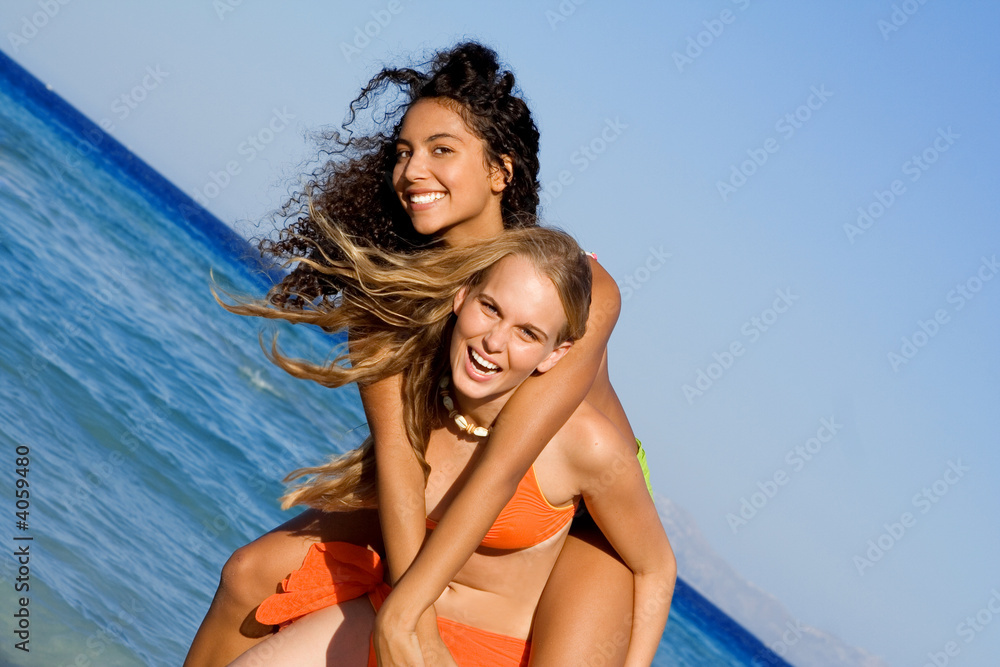 piggyback fun on summer vacation, happy smiling teens