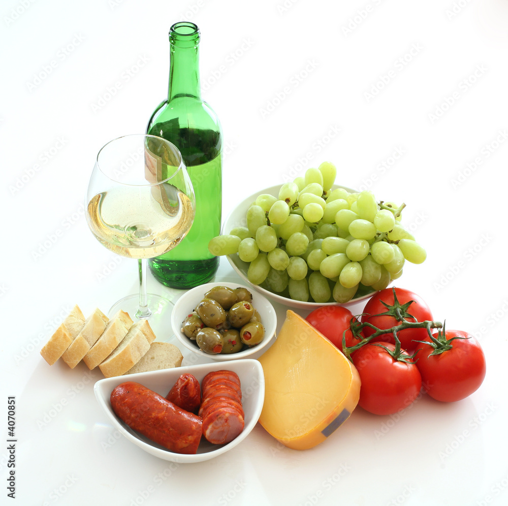 Wine, grapes, bread, tomato, sausage, olives and cheese