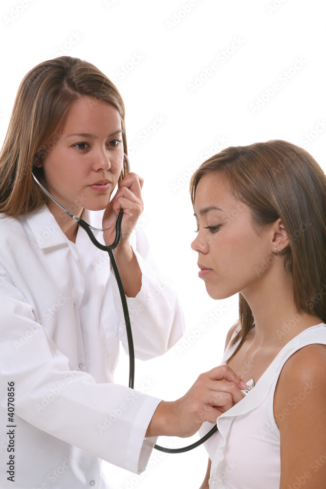 A pretty woman doctor checking on a patient A pretty woman doctor checking on a patient