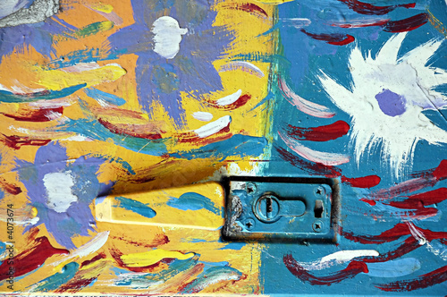 painted lock on a multi colored metal door