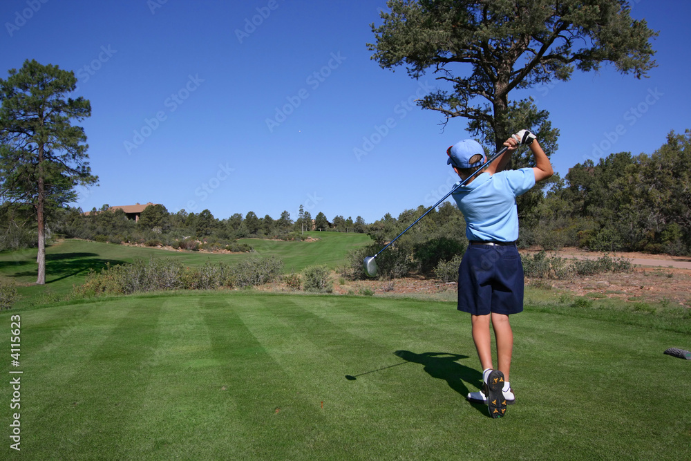 Young golfer hitting a nice tee shot Young golfer hitting a nice tee shot