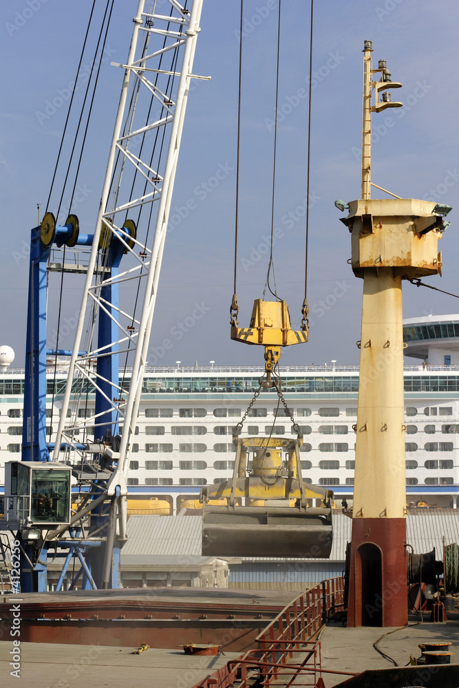 Naklejka premium freight ship being loaded with aggregate