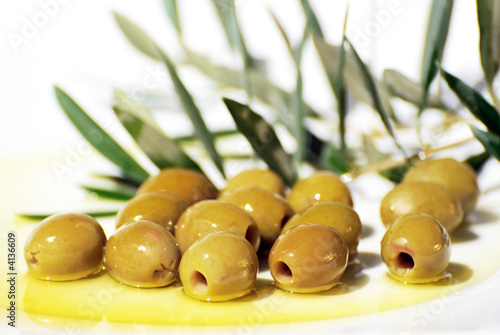 Tapas olives on plate and olive oil