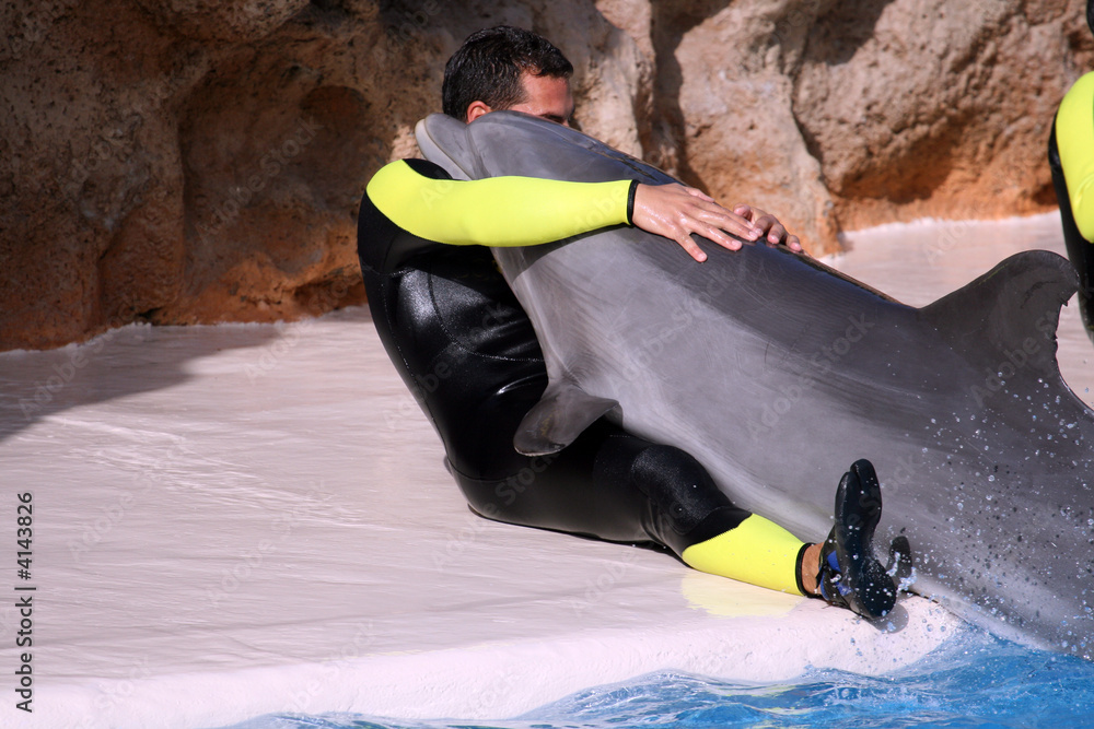 Fototapeta premium man with dolphin in arms