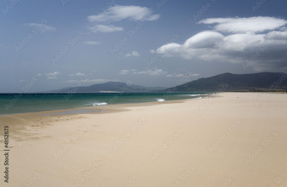 Sandy beach in Spain. Sky and clouds.