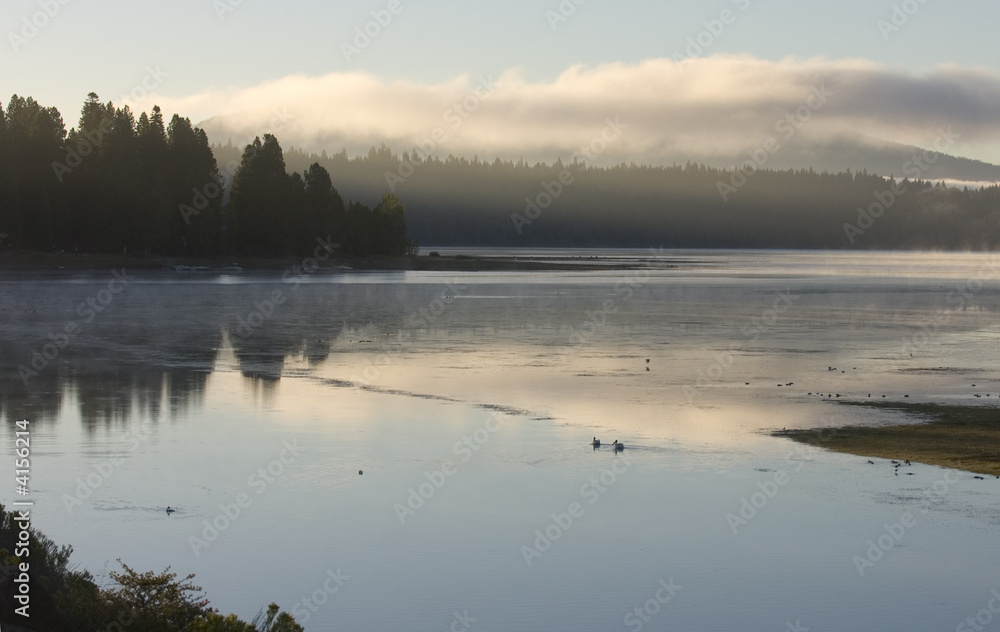 Fototapeta premium Misty morning sunrise on lake almanor