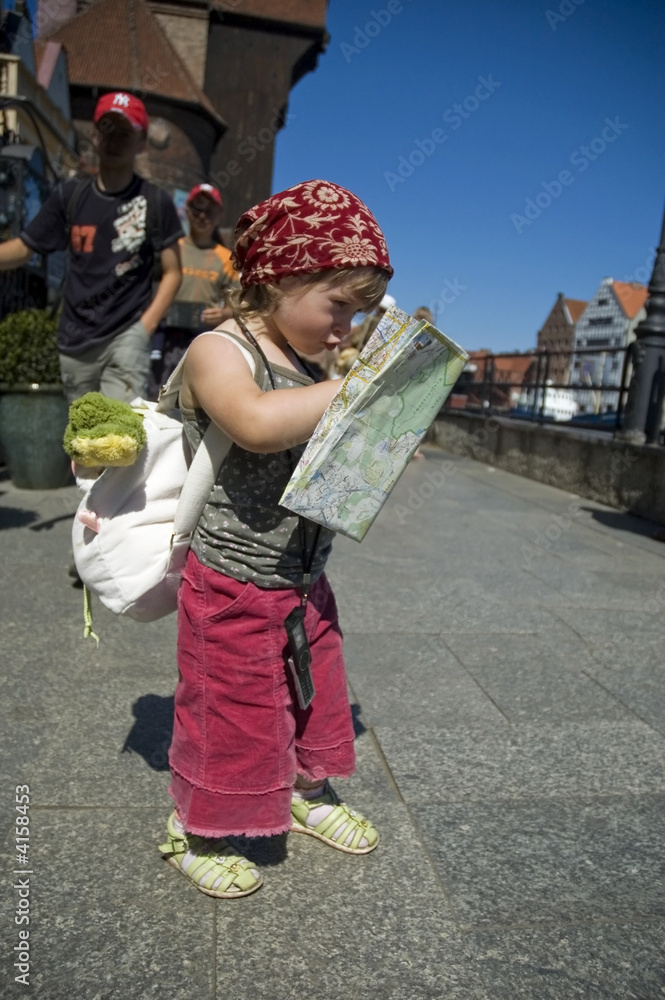 little girl with a city map. travel
