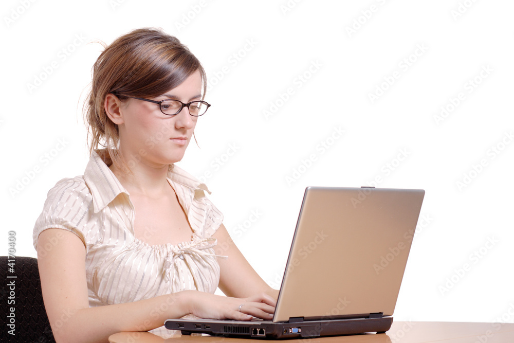 Young woman in an office working on a laptop computer