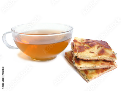 Tea cup with pie with cheese and parsley