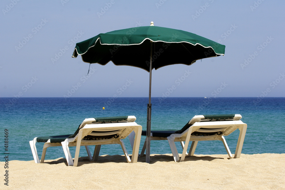 sun lounger on sandy beach