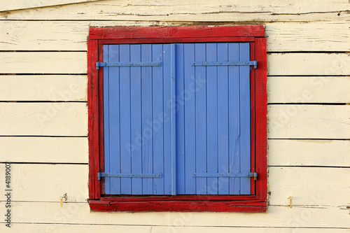 painted window shutters on beach hut