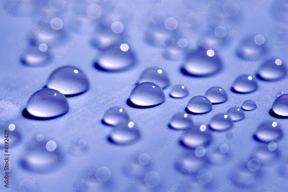 Water drops on blue background close-up