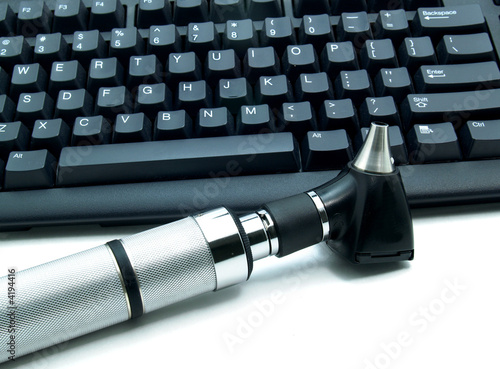 Picture of Otoscope next to computer keyboard