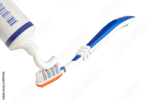Toothpaste being applied on a toothbrush 