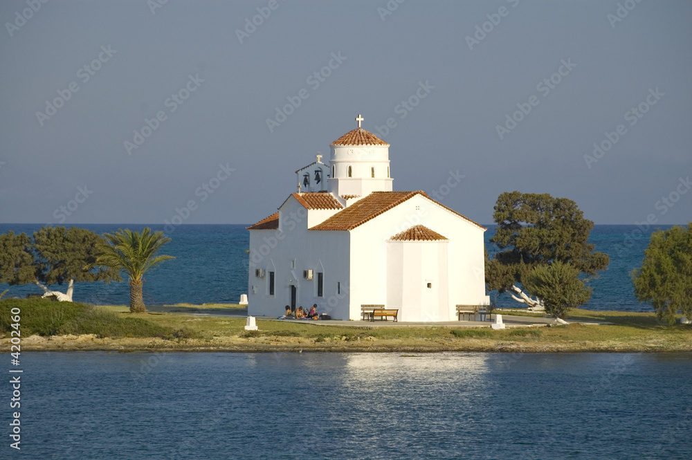 View over antique white european church on an island