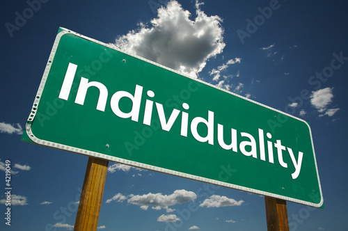 Individuality Road Sign with dramatic blue sky and clouds.