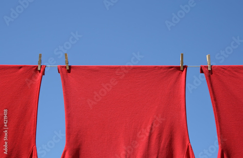 Red t-shirts on a clothes-line