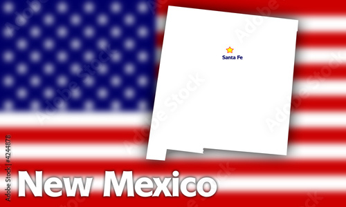 New Mexico state contour against blurred USA flag