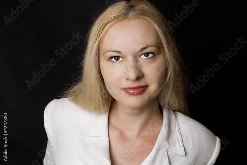 Smiling businesswoman in white on black