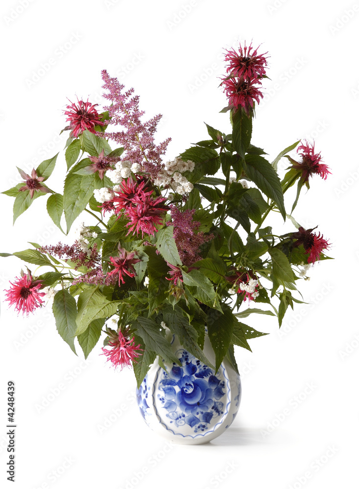 bunch of flowers in glass blue white vase