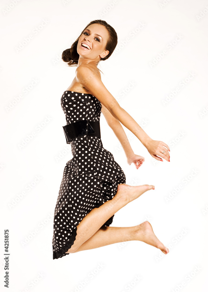 Naklejka premium jumping brunette girl on white background