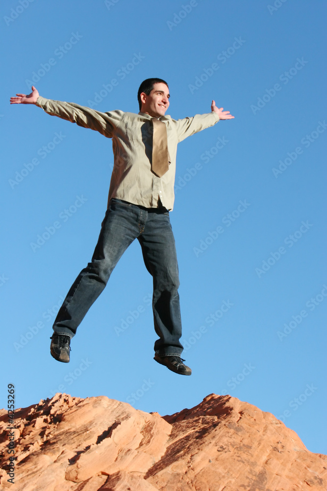 Ecstatic businessman jumping in the air
