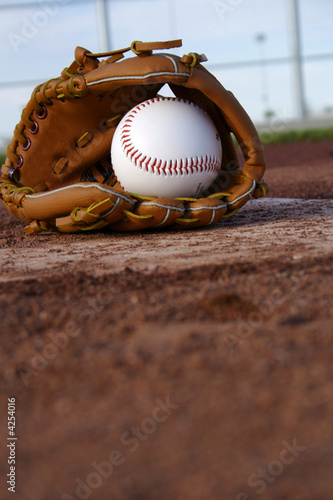 Baseball & Glove on Baseball Field photo