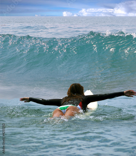 Young girl surfing on Malibu Beach, California