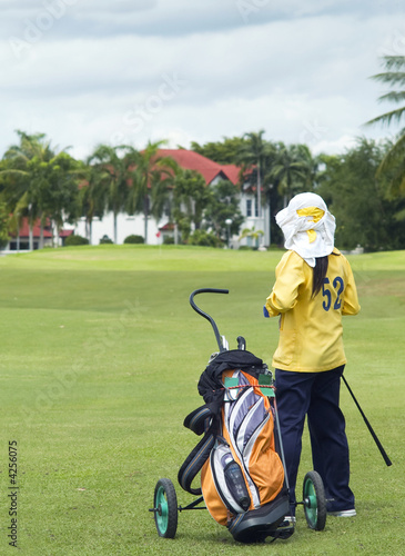 Colf caddie on the fairway
