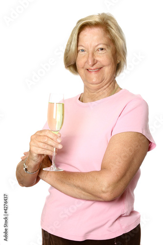Very happy mature woman holding a glass of champagne, 