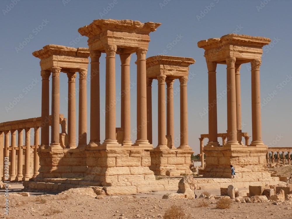 Four Ancient columns, ruins and a girl, Palmyra, Syria
