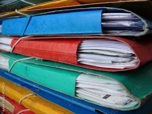 Pile of colorful, paper, cardboard office files and paperwork