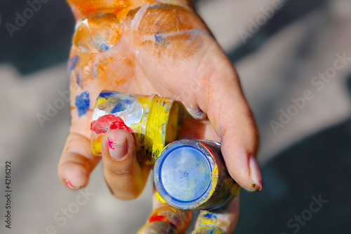 female hand with color tubes photo