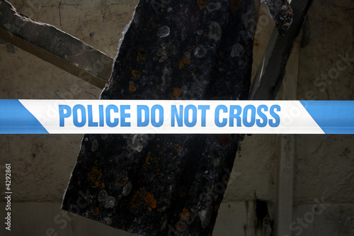 Close up of a line of British Police do not cross tape.