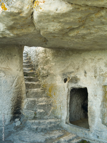 Stairs in stony cave house photo