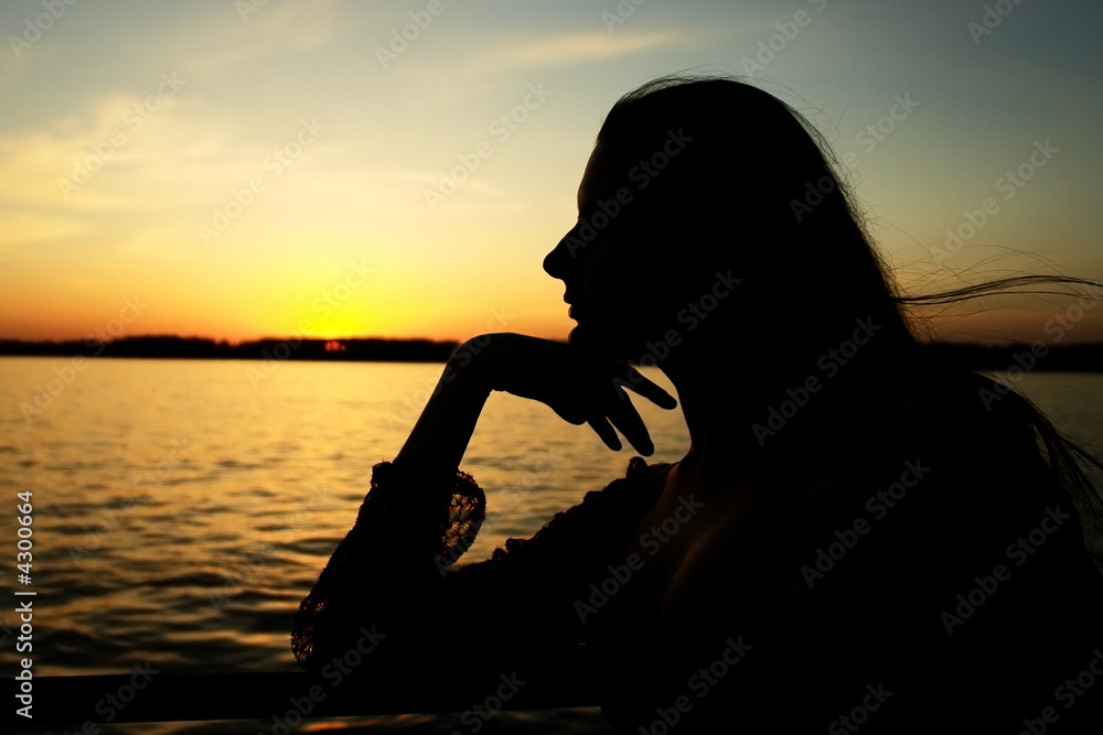 Girl on the sunset background.