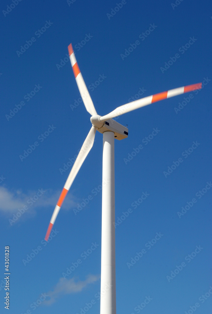 wind mill power generator against blue sky