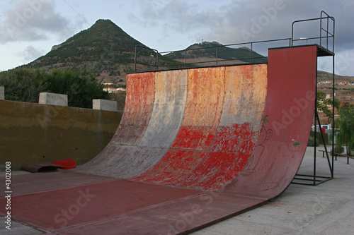 deteriorated skate half pipe at sunset
