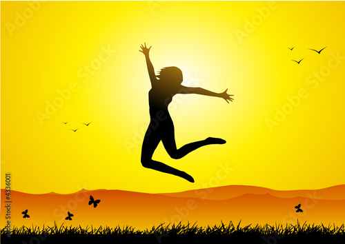 Happy girl jumping at sunset