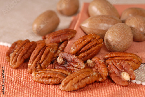 Whole and shelled pecans on a table photo