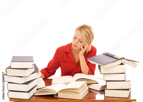 Woman studiyng with lots of books