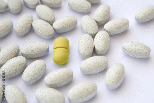 Yellow pill among gray tablets