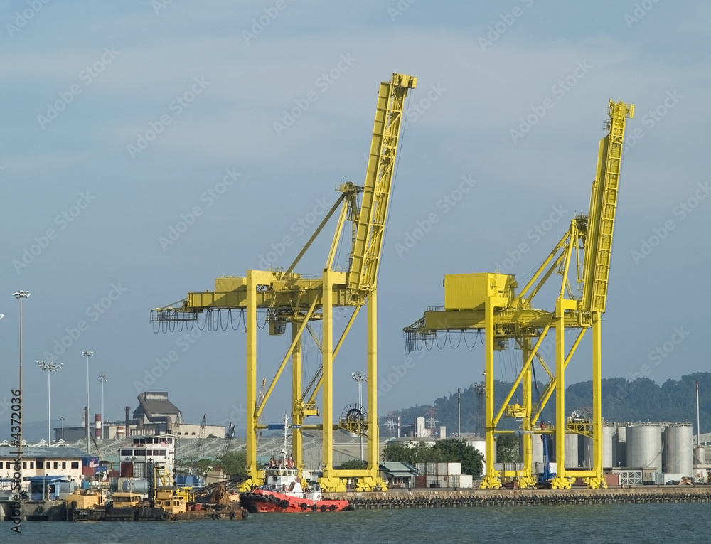 Two container cranes in a harbour