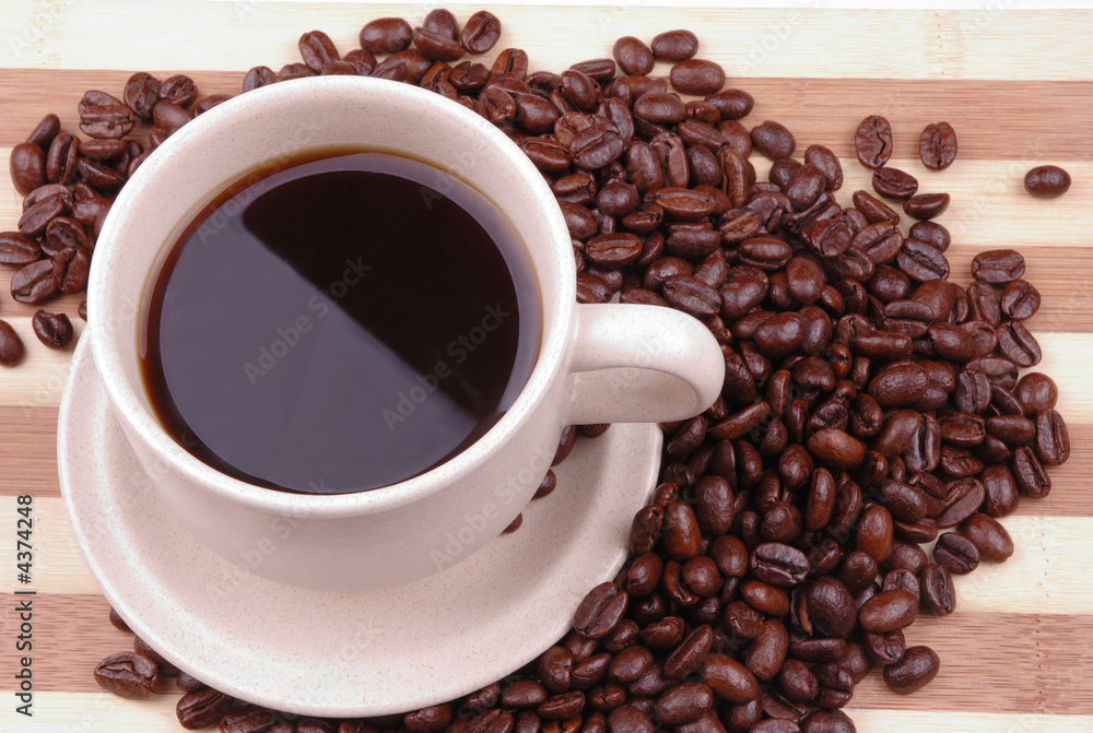 Fototapeta premium a cup of coffee with beans as background