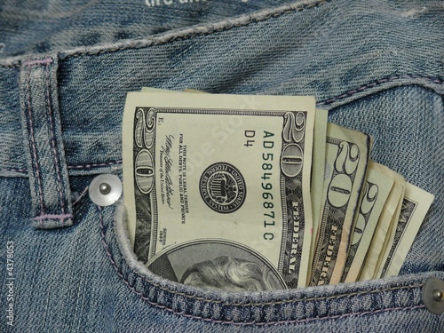 Pocket money, fan of american dollars in jeans pocket